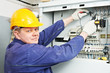 Electrician measure voltage with multimeter