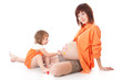 Daughter is painting on her mother's belly Daughter is painting on her mother's belly