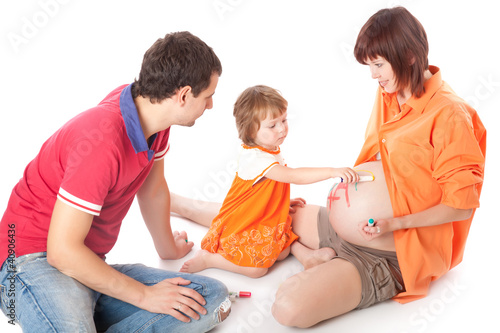 Photo: Daughter is painting on her mother's belly Daughter is painting on her mother's belly