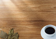 Coffee and dry leaf on wood background