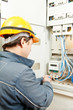 Electrician installing energy saving meter Electrician installing energy saving meter