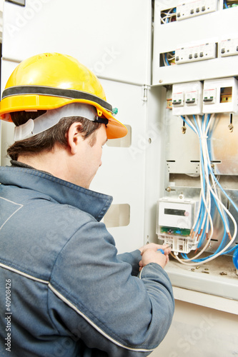 Photo: Electrician installing energy saving meter Electrician installing energy saving meter
