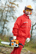 Lumberjack Worker With Chainsaw In The Forest
