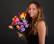 Photo: Happy, young, beautiful woman with a bouquet of spring flowers Happy, young, beautiful woman with a bouquet of spring flowers