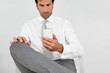Businessman reading short message on mobile phone