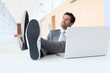 Businessman relaxing wih feet on desk