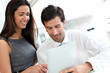 Business people websurfing on tablet during breaktime