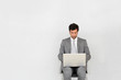 Businessman sitting on chair in front of laptop