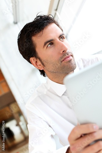 Photo: Businessman working on electronic tablet Businessman working on electronic tablet