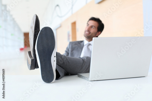 Photo: Businessman relaxing wih feet on desk Businessman relaxing wih feet on desk