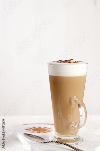 Photo: coffee latte with frothy milk in tall glass coffee latte with frothy milk in tall glass