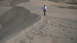 Young businessman walking on the desert