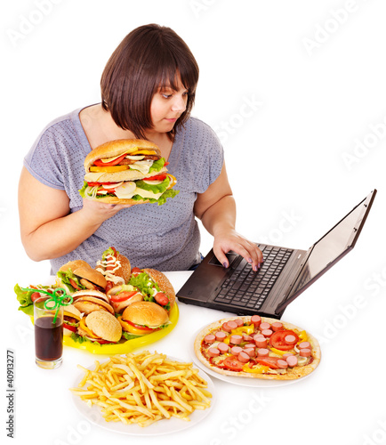 Photo: Woman eating junk food. Woman eating junk food.