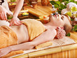Woman getting massage in bamboo spa.