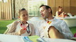 Young couple talking and drinking exotic cocktails