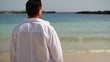 Young man standing on the beach