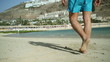 Young man walking on the beach