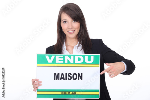 Photo: French Estate Agent with a 'Vendu' sign French Estate Agent with a 'Vendu' sign