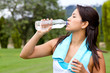 Athletic woman drinking water