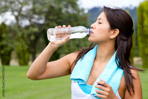 Photo: Athletic woman drinking water Athletic woman drinking water