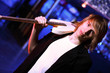 Young guitar player performing in night club