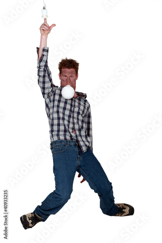 Photo: Man putting finger in electrical socket Man putting finger in electrical socket