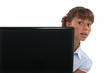 Woman peeking out from behind a laptop