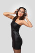 Young woman in evening dress with headphones Young woman in evening dress with headphones