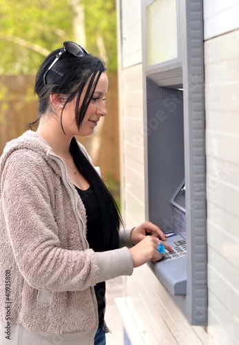 Photo: beautiful woman using ATM beautiful woman using ATM