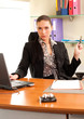 Business woman sitting in the office in front of the laptop
