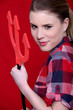 A cute woman holding the evil pitchfork.
