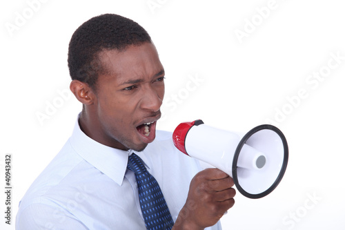 Photo: African man shouting through a megaphone African man shouting through a megaphone