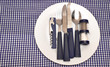 Tableware on blue napkin