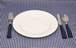 Tableware on blue napkin