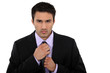Businessman fixing his tie Businessman fixing his tie