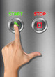 Human hand pressing start button on metalic background Human hand pressing start button on metalic background