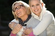 Mother and daughter hugging in the garden