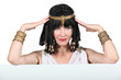 Woman dressed in Egyptian outfit with message board
