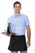Waiter with tray and bottle of beer