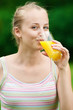 Young woman drinking orange juice. Outdoor Young woman drinking orange juice. Outdoor
