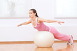 canvas print picture - Woman doing stretching exercise on ball
