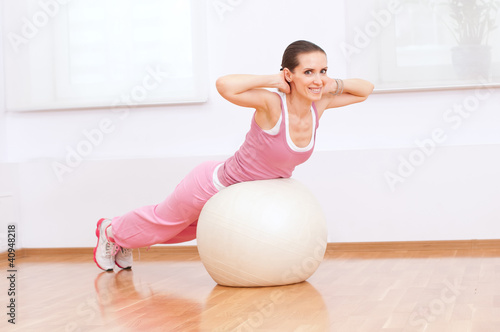 Photo: Woman doing stretching exercise on ball Woman doing stretching exercise on ball