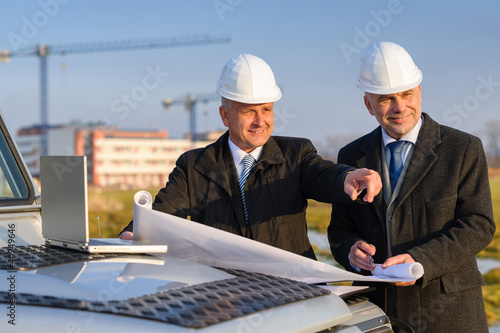 Photo: Architect developer point at construction site Architect developer point at construction site