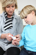 Grandmother healing her grandson's finger