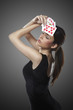 sexy woman with poker cards, she has her eyes closed
