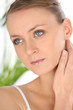Blond woman holding neck