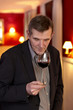 Handsome mature man swirling red wine in a glass.