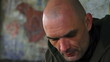 Shaved man wiping nose, close up