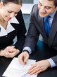 Businesspeople with documents at office Businesspeople with documents at office