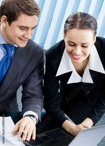 Foto: Businesspeople working with laptop at office Businesspeople working with laptop at office